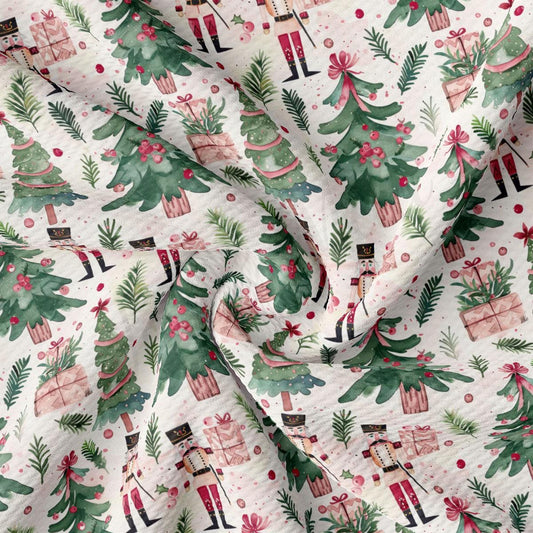 The image is a close-up of a fabric with a repeating pattern of Christmas trees, nutcrackers, and presents.