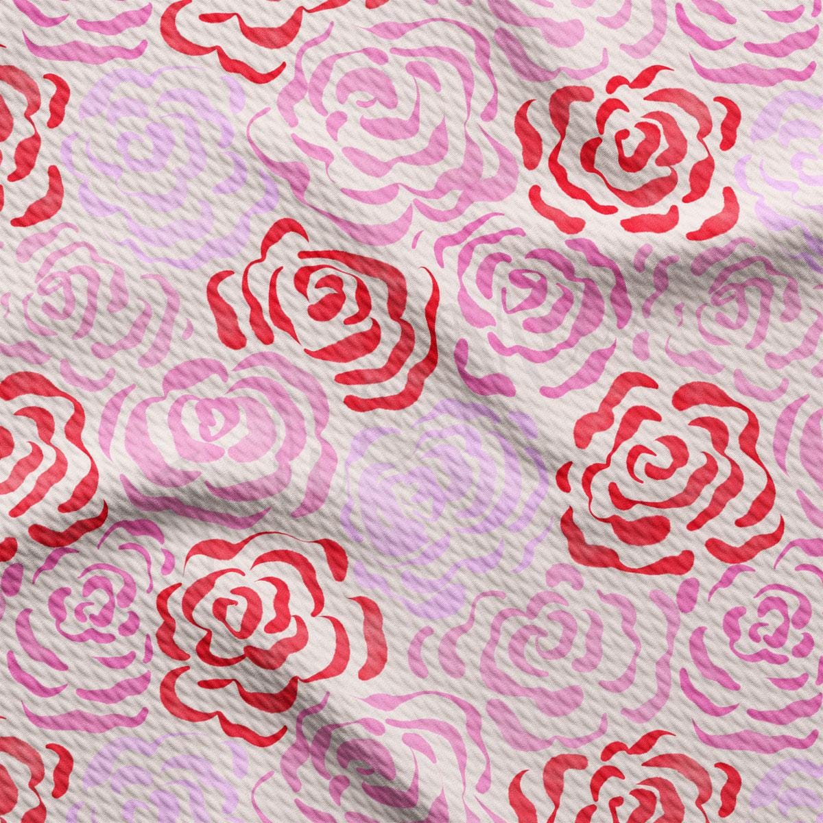 a close up of a pink and red rose print fabric