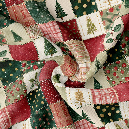 The image is a close-up of a fabric with a patchwork design featuring various Christmas-themed elements such as trees, berries, and plaid patterns.
