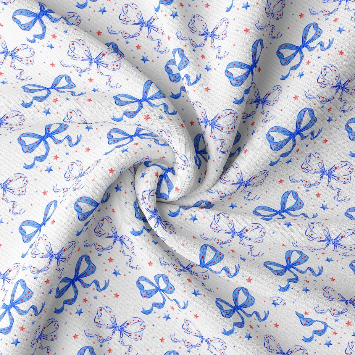 a close up of a white fabric with blue and red bows
