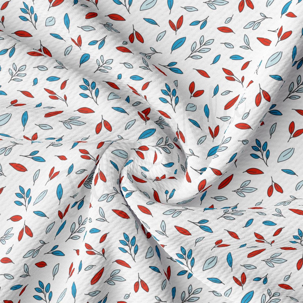 a white fabric with red and blue leaves on it