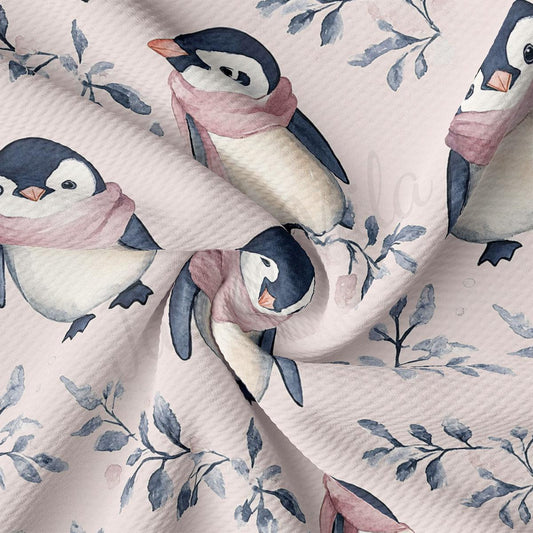 a close-up view of a fabric with a repeating pattern of penguins wearing pink scarves and surrounded by leaves.