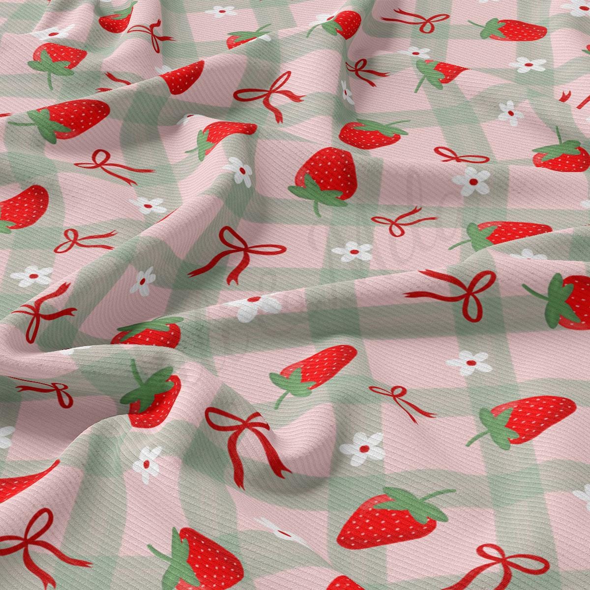 a pink and green checkered fabric with strawberries on it