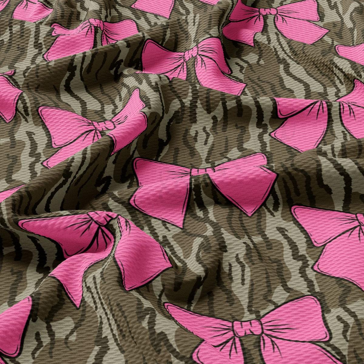 a close up of a pink bow on a brown background