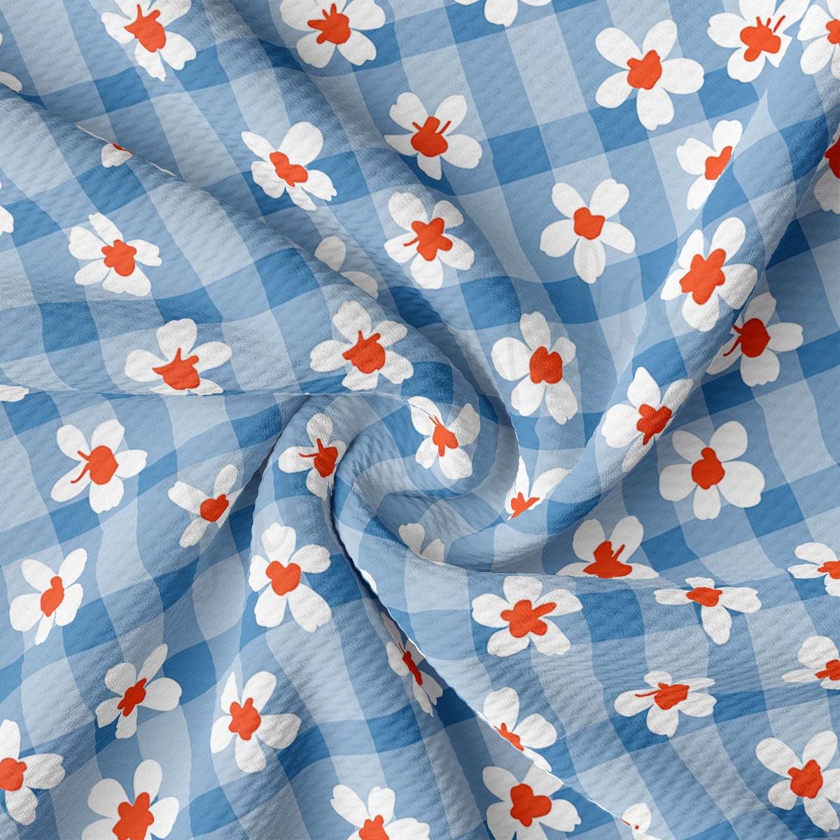 a blue and white checkered fabric with red and white flowers