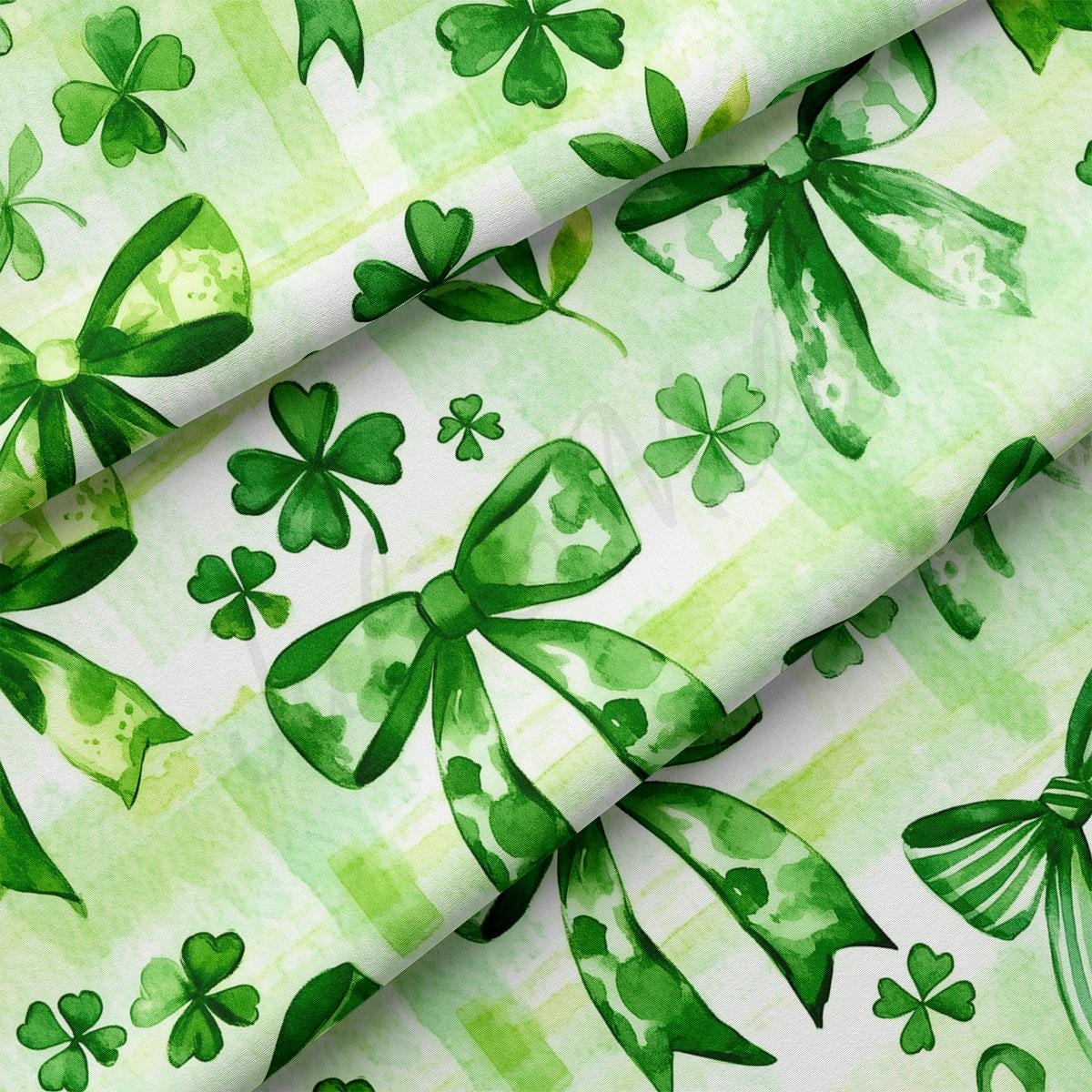a close up of a green and white background with shamrocks