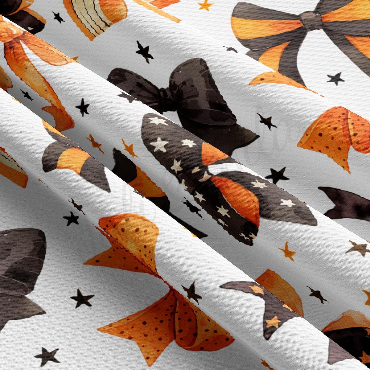 a close-up view of a fabric with a repeating pattern of orange and black bows and stars.