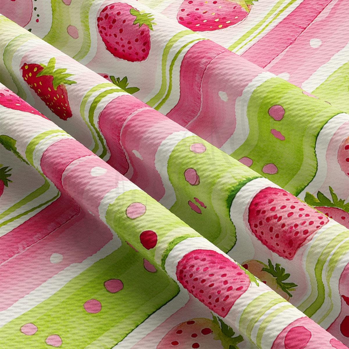 a close up of a pink and green fabric with strawberries on it