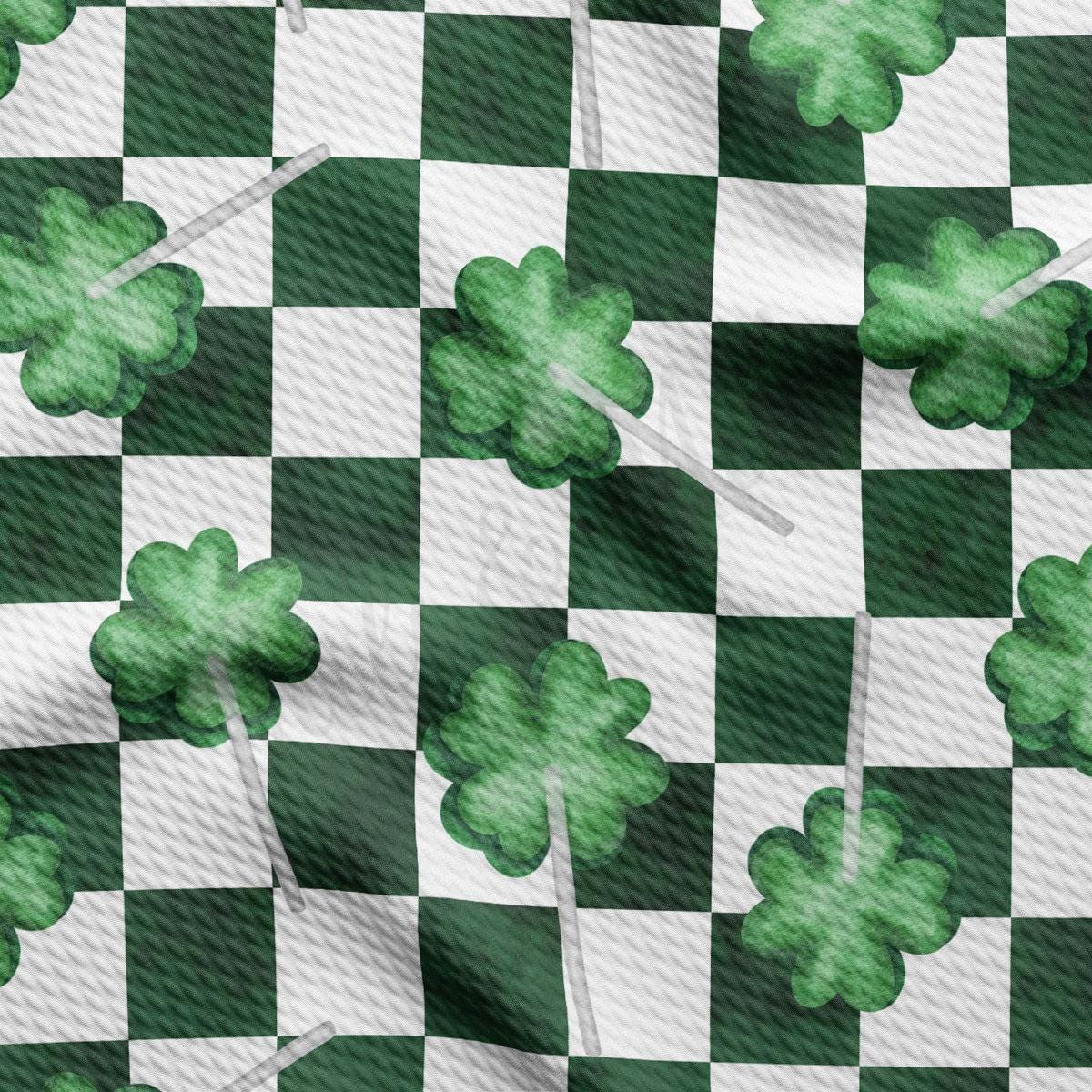 a green and white checkered pattern with four leaf clovers