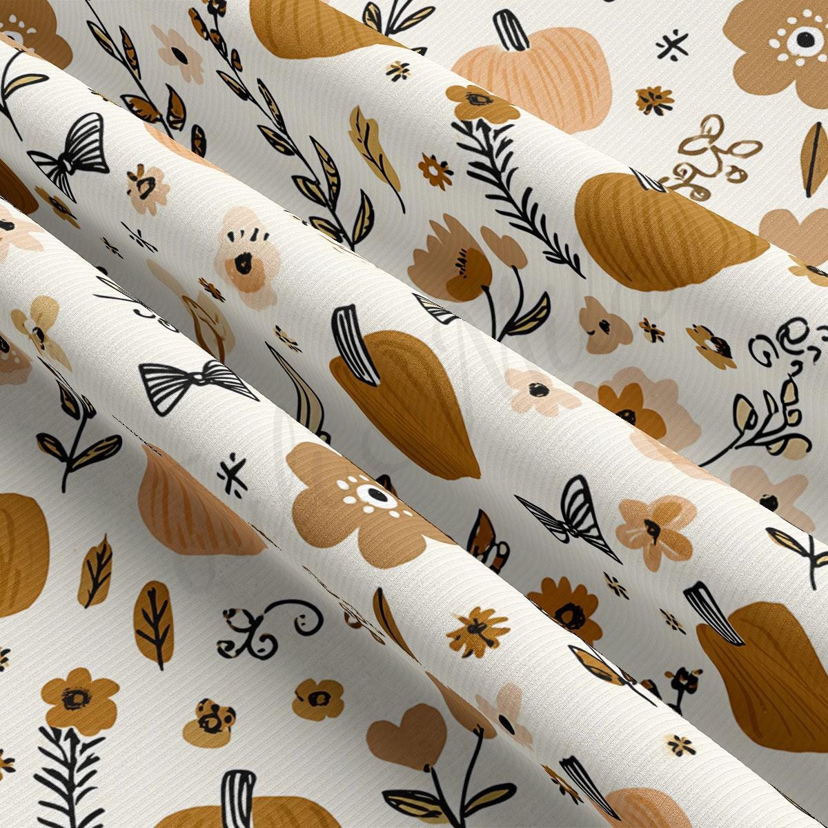 The image is a close-up view of a fabric with a repeating pattern of brown pumpkins, flowers, and leaves. The pattern is predominantly white, with the pumpkins and flowers in shades of brown and orange, and the leaves in black and brown. The fabric appears to be folded or rolled, revealing the intricate design and texture of the pattern.