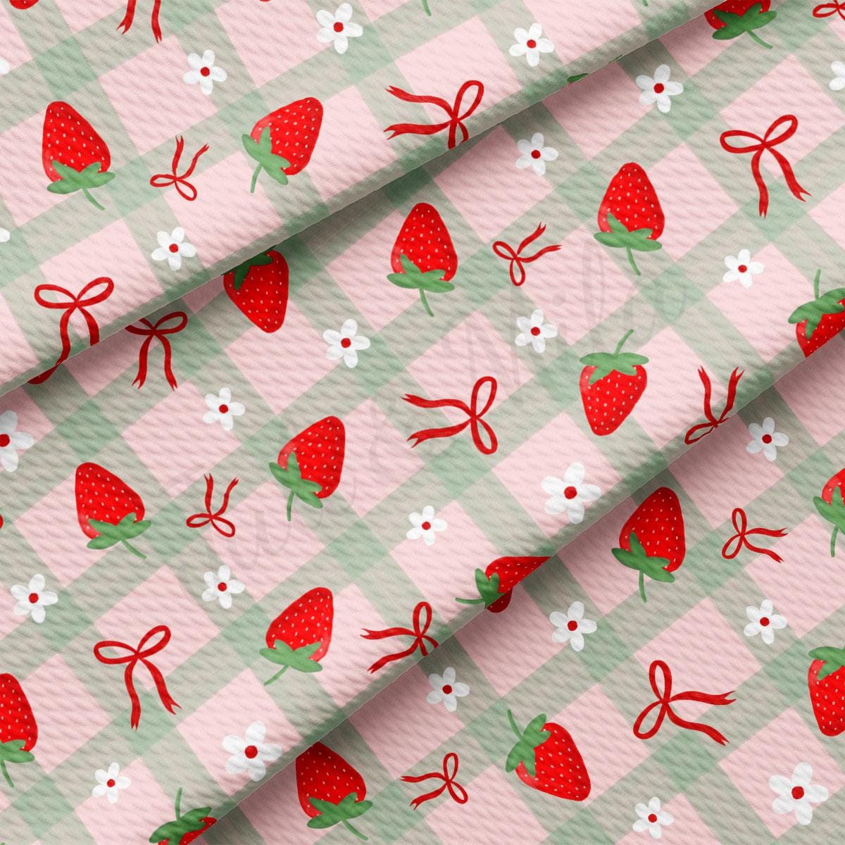 a pink and green checkered fabric with strawberries on it