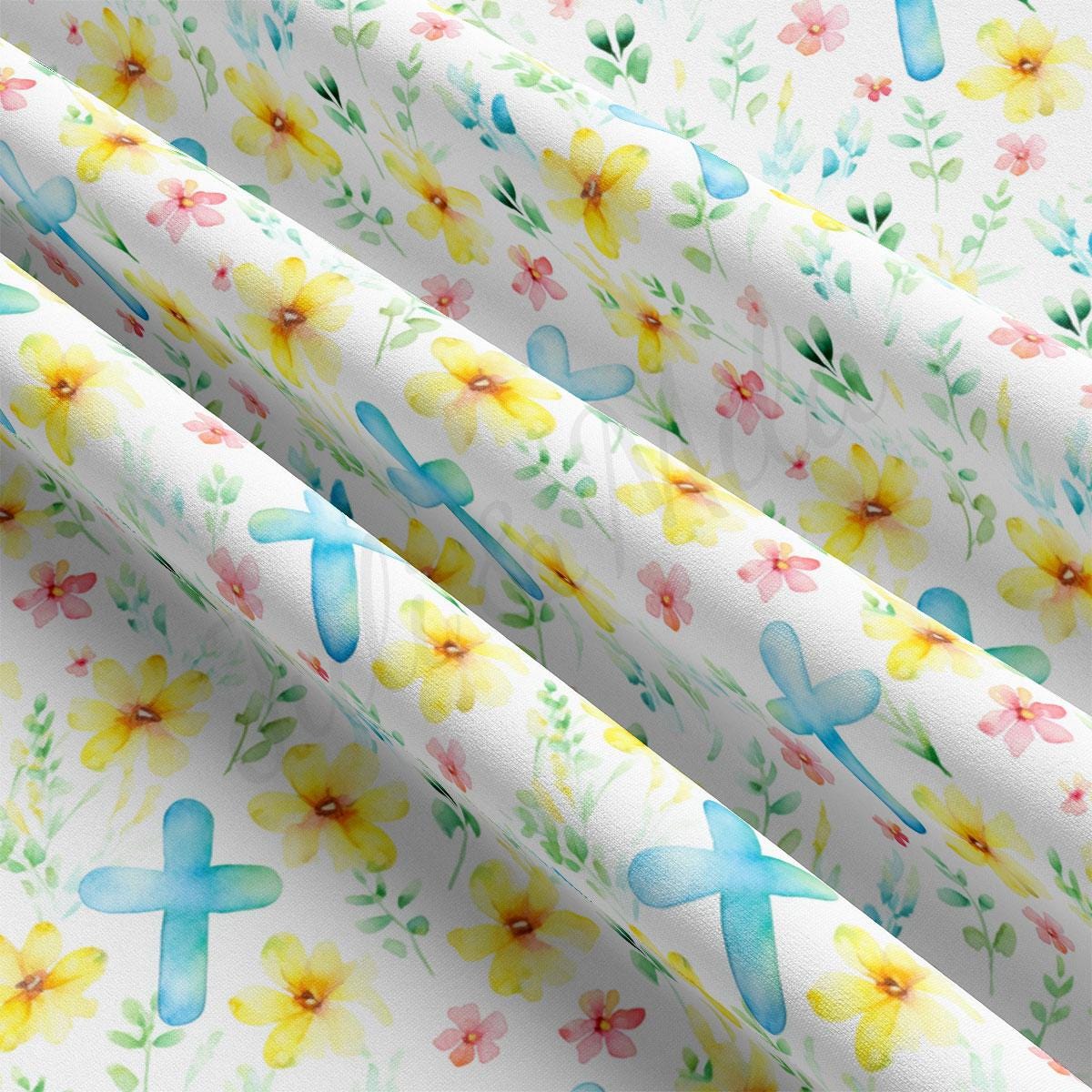 a close up of a flowered paper with a cross on it
