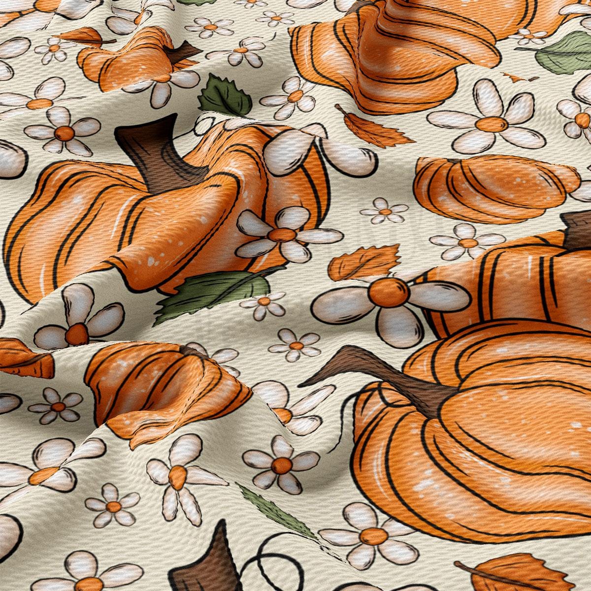 a close-up view of a fabric with a repeating pattern of orange pumpkins and white flowers.