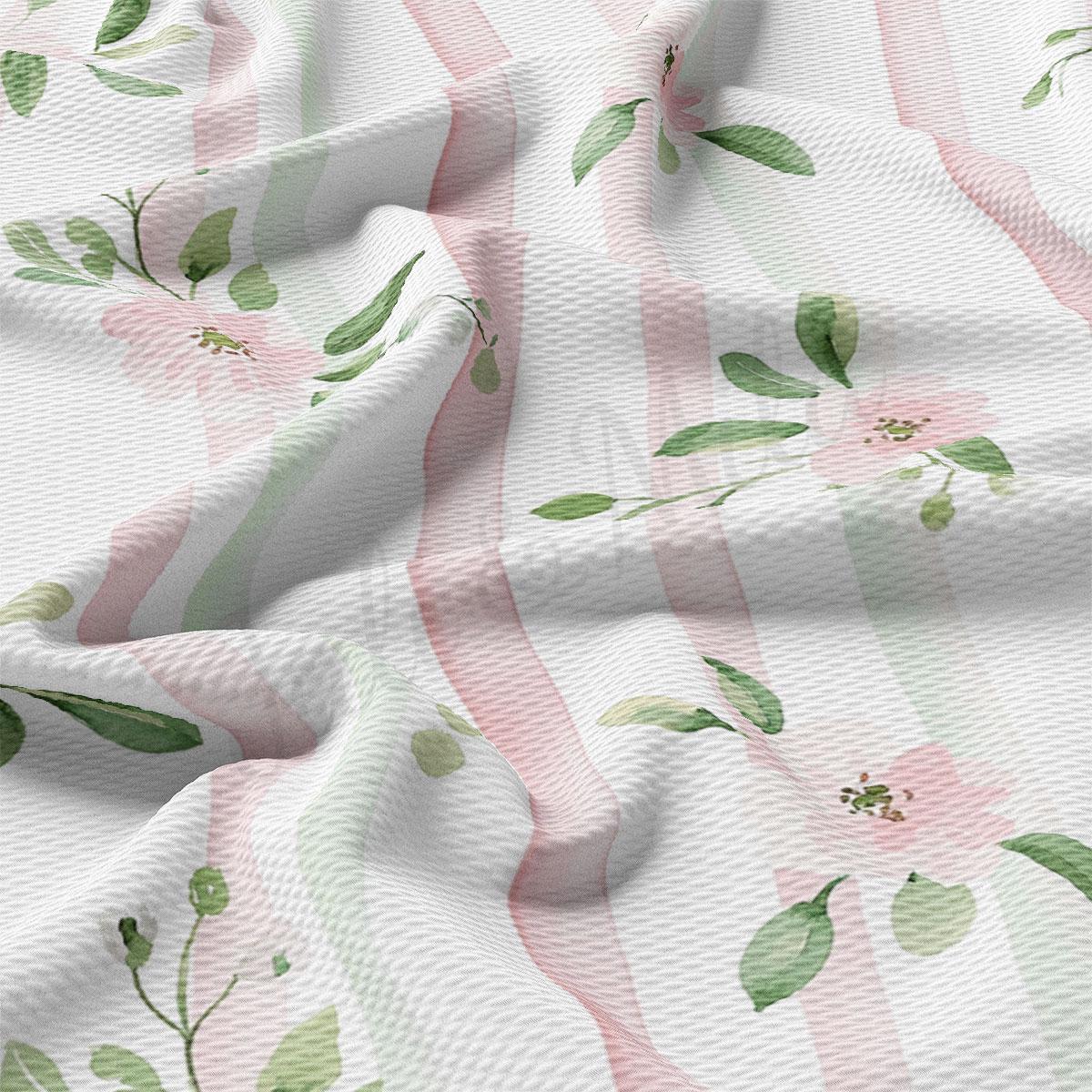 a close-up view of a fabric with a floral pattern. The fabric has pink and green stripes and leaves, creating a visually appealing design.