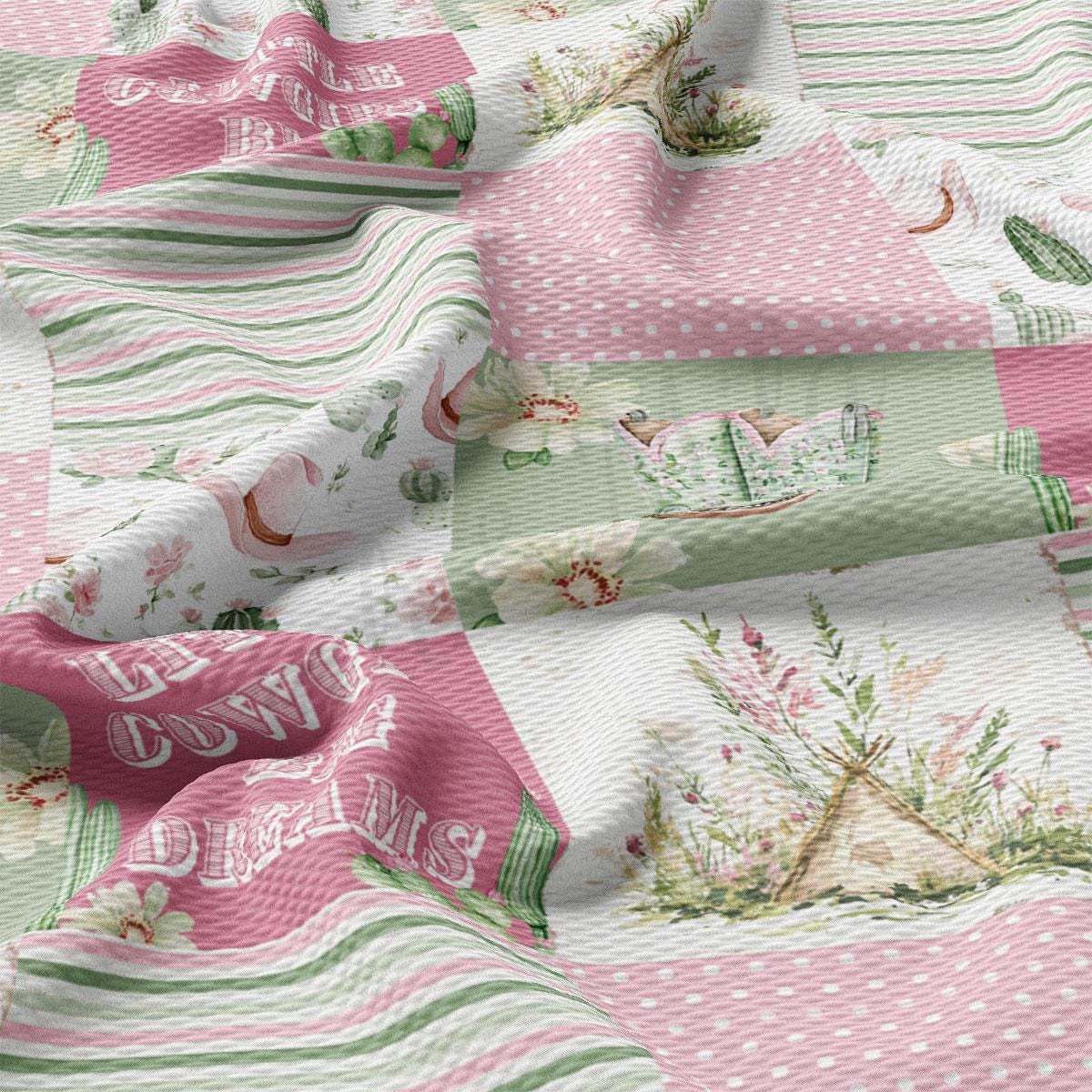 The image is a close-up of a fabric with a floral and polka dot pattern. The fabric appears to be a quilt or textile with various colorful and textured elements, including a pink and green floral design, polka dots, and a small teepee-like structure.