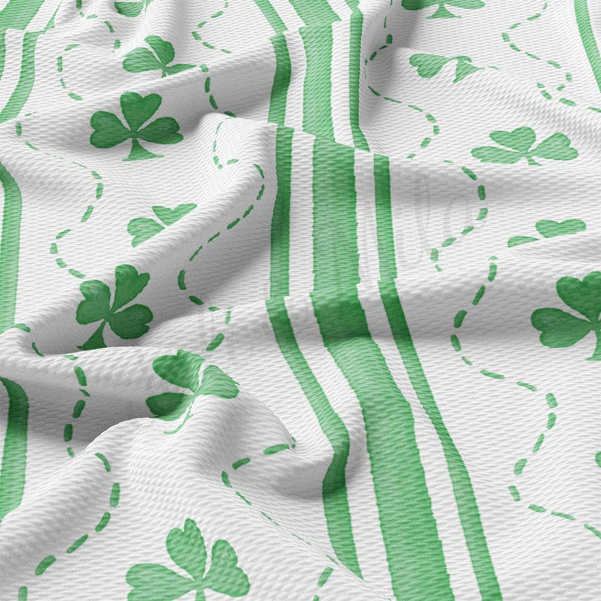 a green and white striped fabric with shamrocks on it