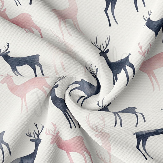 a close-up view of a fabric with a repeating pattern of deer silhouettes in shades of pink and black.