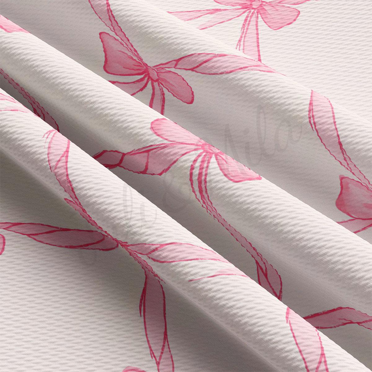 a close-up view of a fabric with a repeating pink bow pattern. The bows are arranged in a diagonal pattern across the fabric, creating a visually striking design.