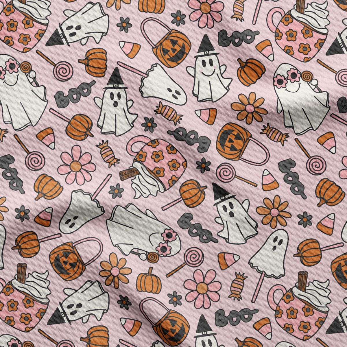 a pink background with lots of halloween themed items