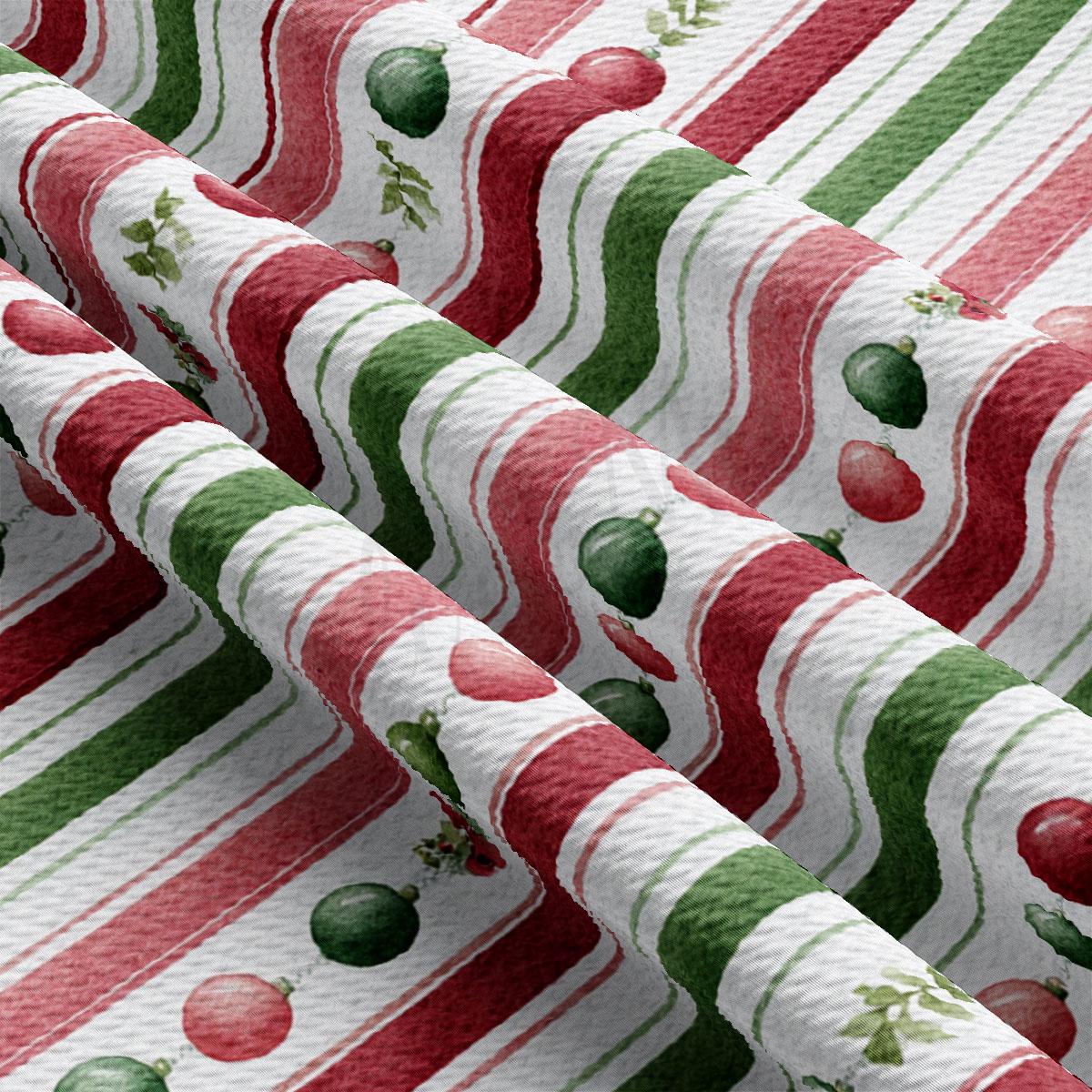 a close-up view of a fabric with a repeating pattern of red, green, and white stripes. The pattern includes various shapes and objects, such as apples and balls, creating a festive and colorful design.