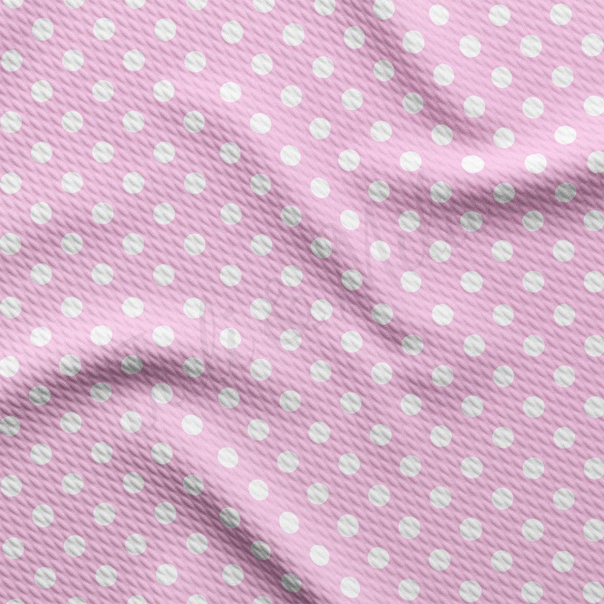 a pink and white polka dot fabric