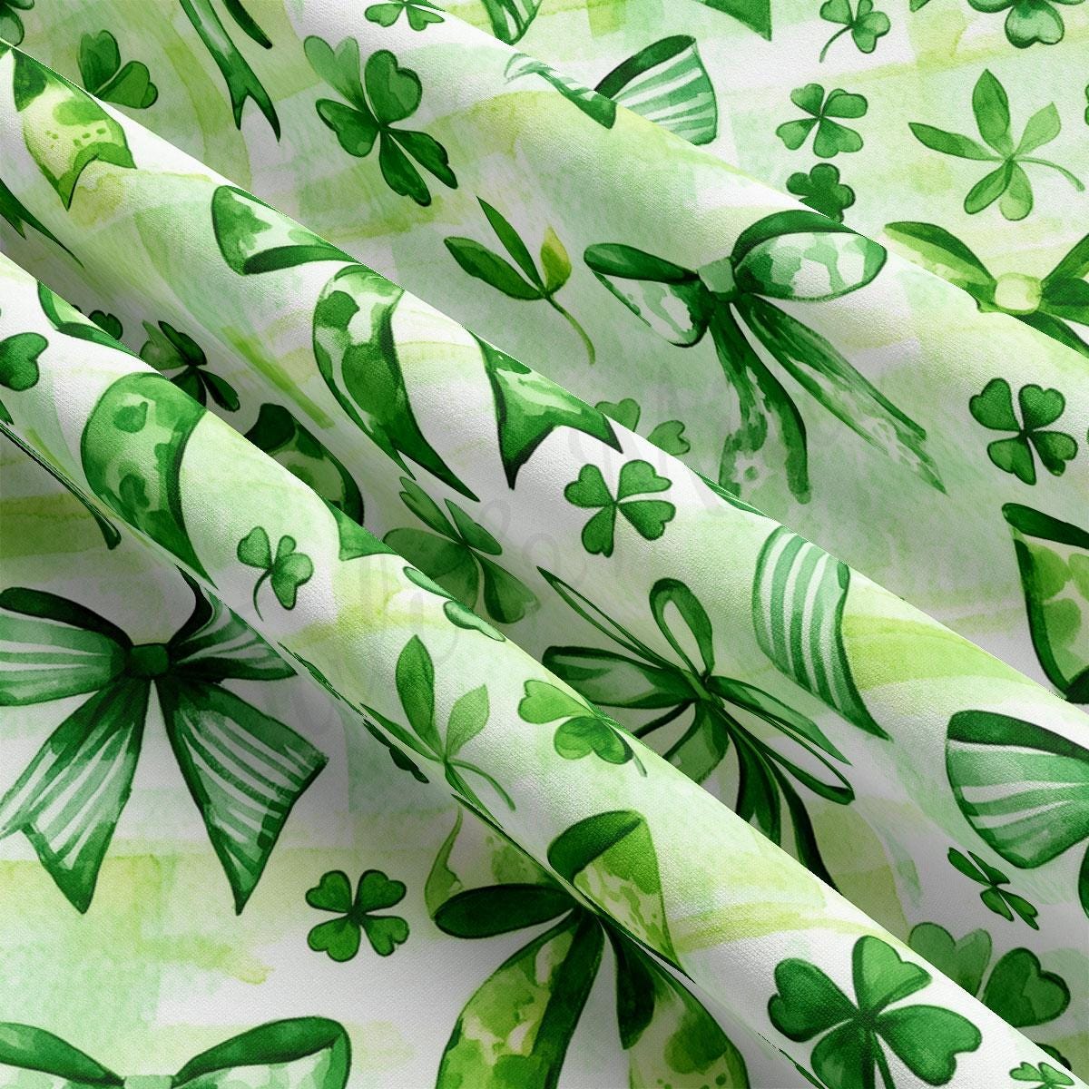 a close up of a green and white fabric with shamrocks on it