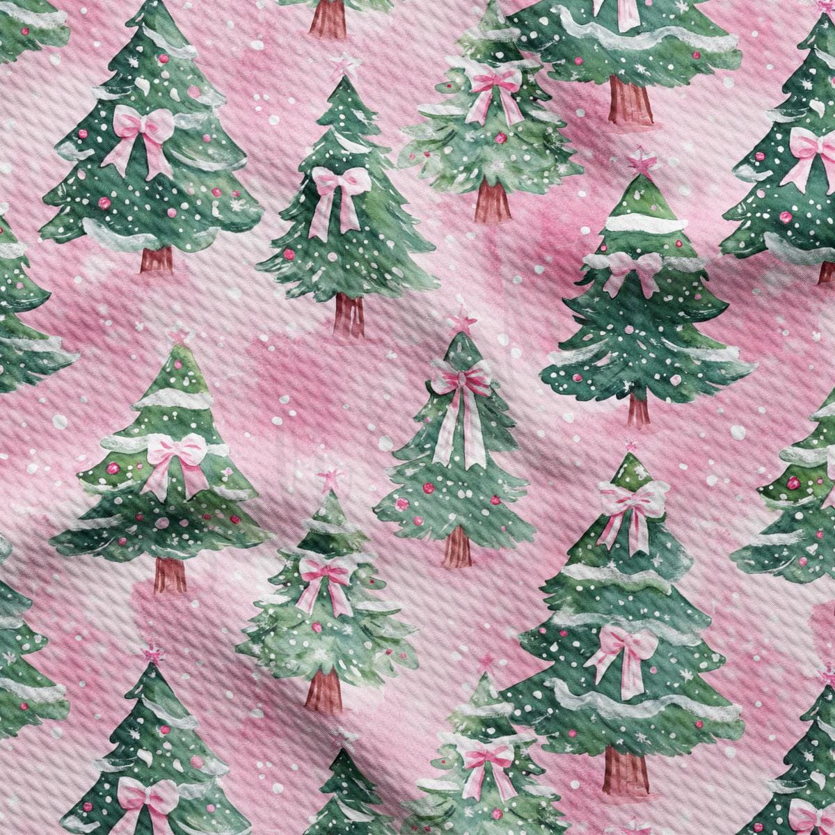 a repeating pattern of Christmas trees with pink bows on a pink background.