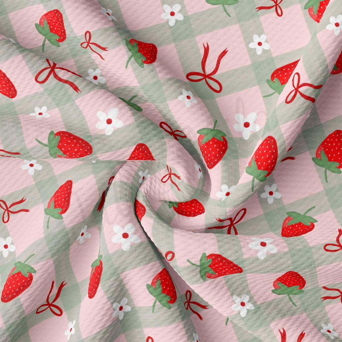a pink and green checkered fabric with strawberries on it