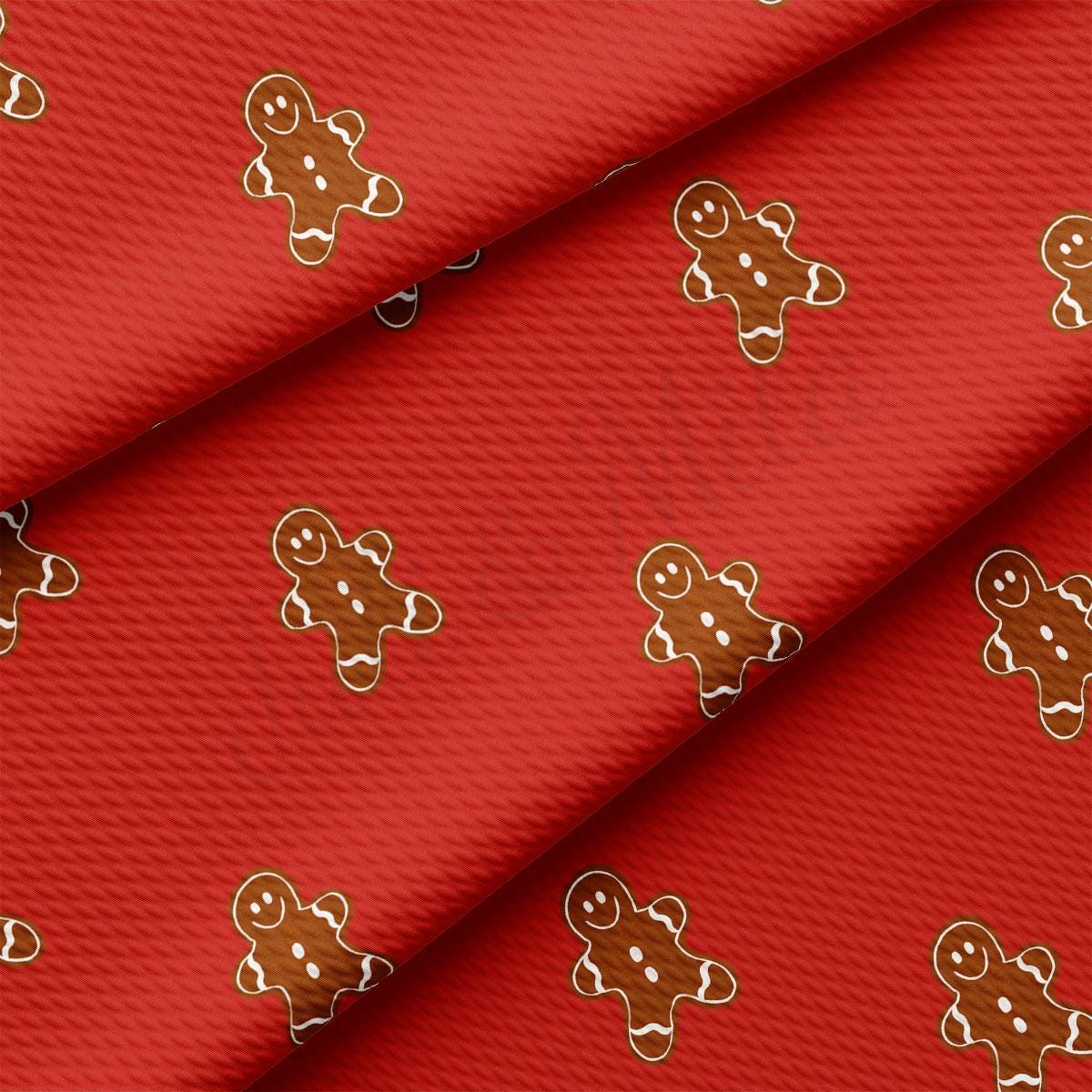 a close up of a red fabric with ginger cookies on it