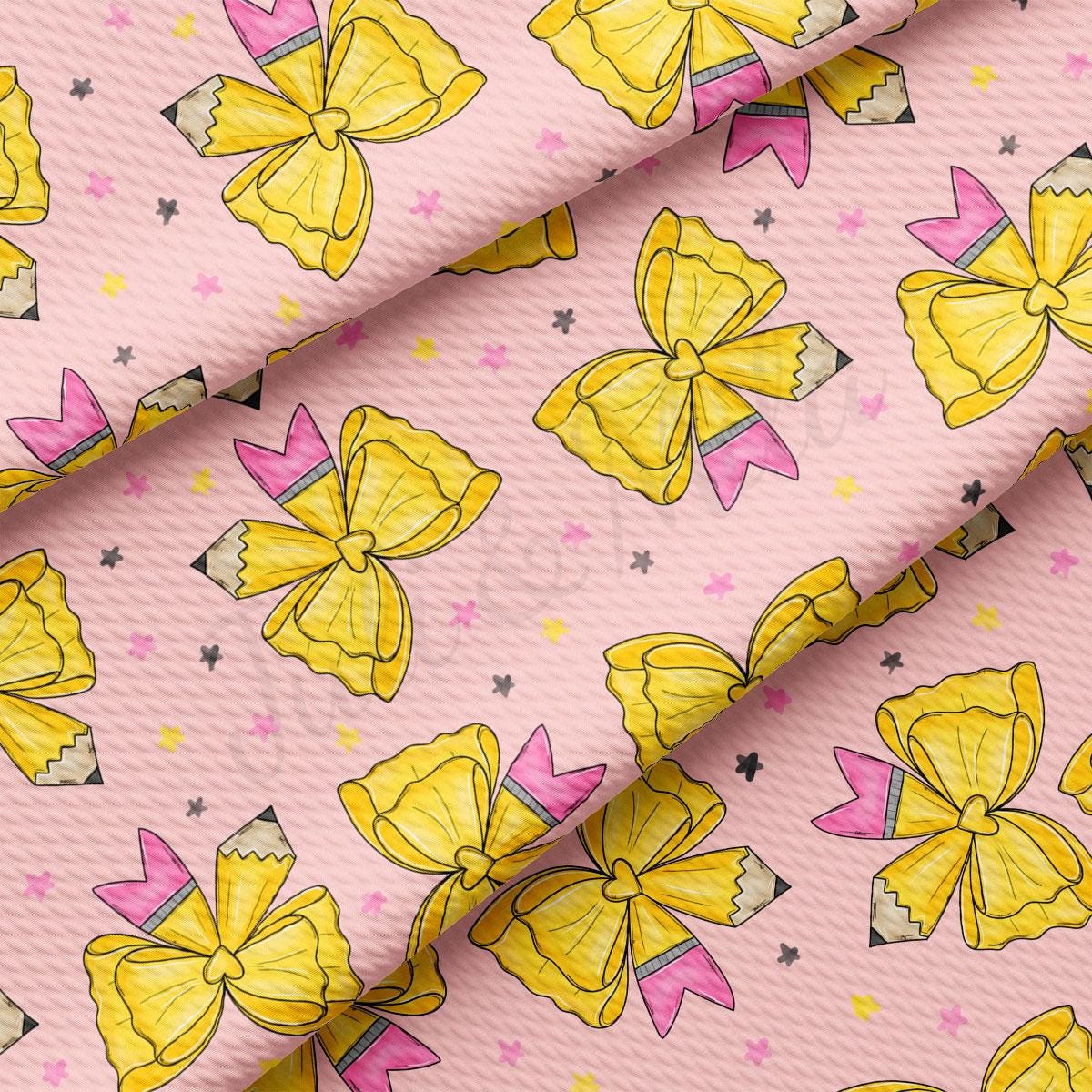 a repeating pattern of yellow and pink bows on a pink background, with small black and white stars scattered throughout the pattern.