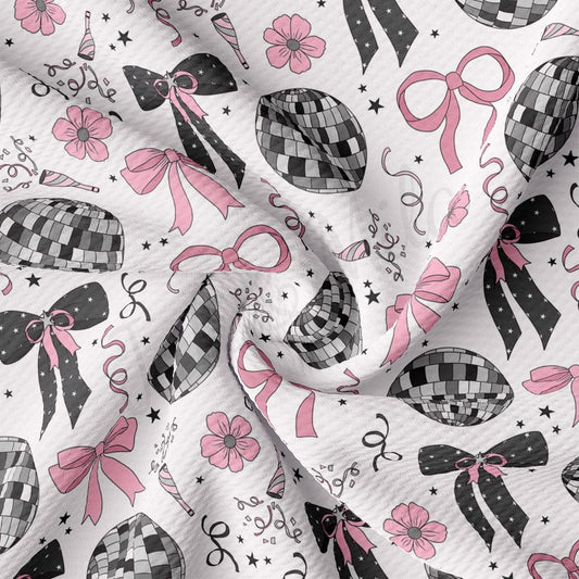 a white fabric with pink bows and bows on it