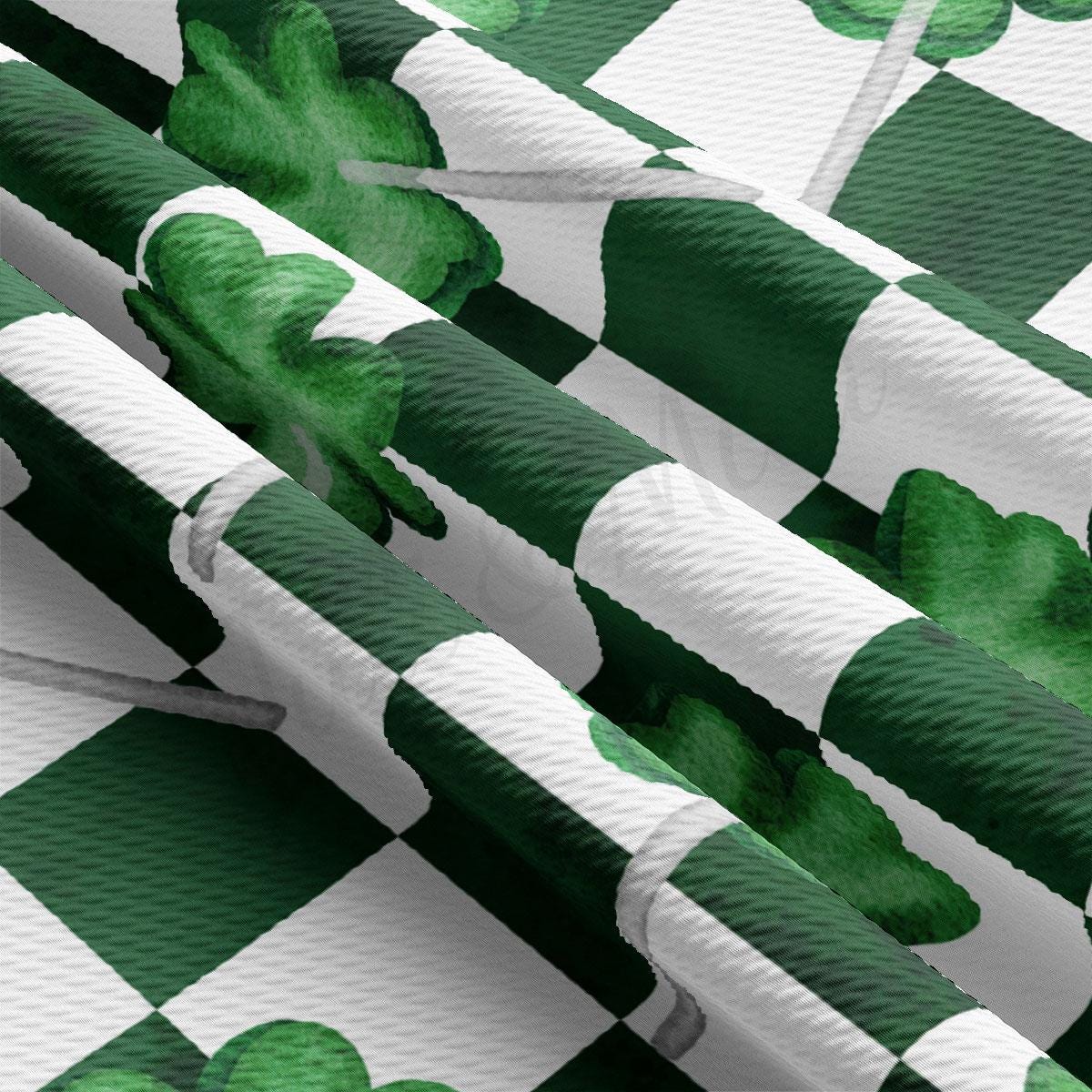 a green and white checkered pattern with shamrocks