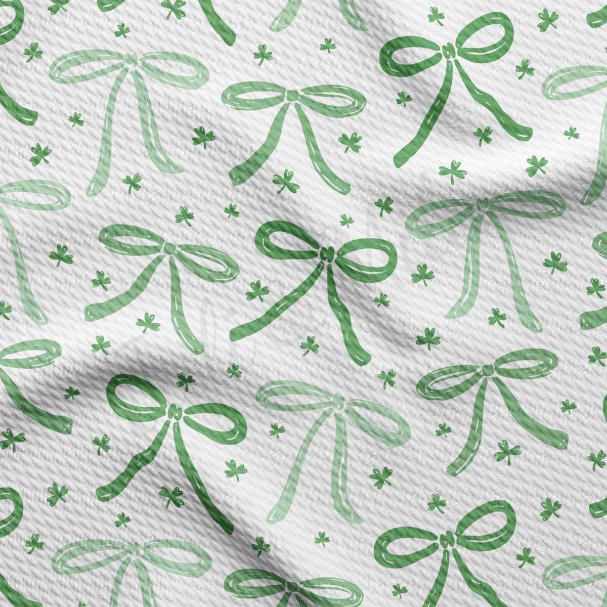 a pattern of green bows and shamrocks on a white background