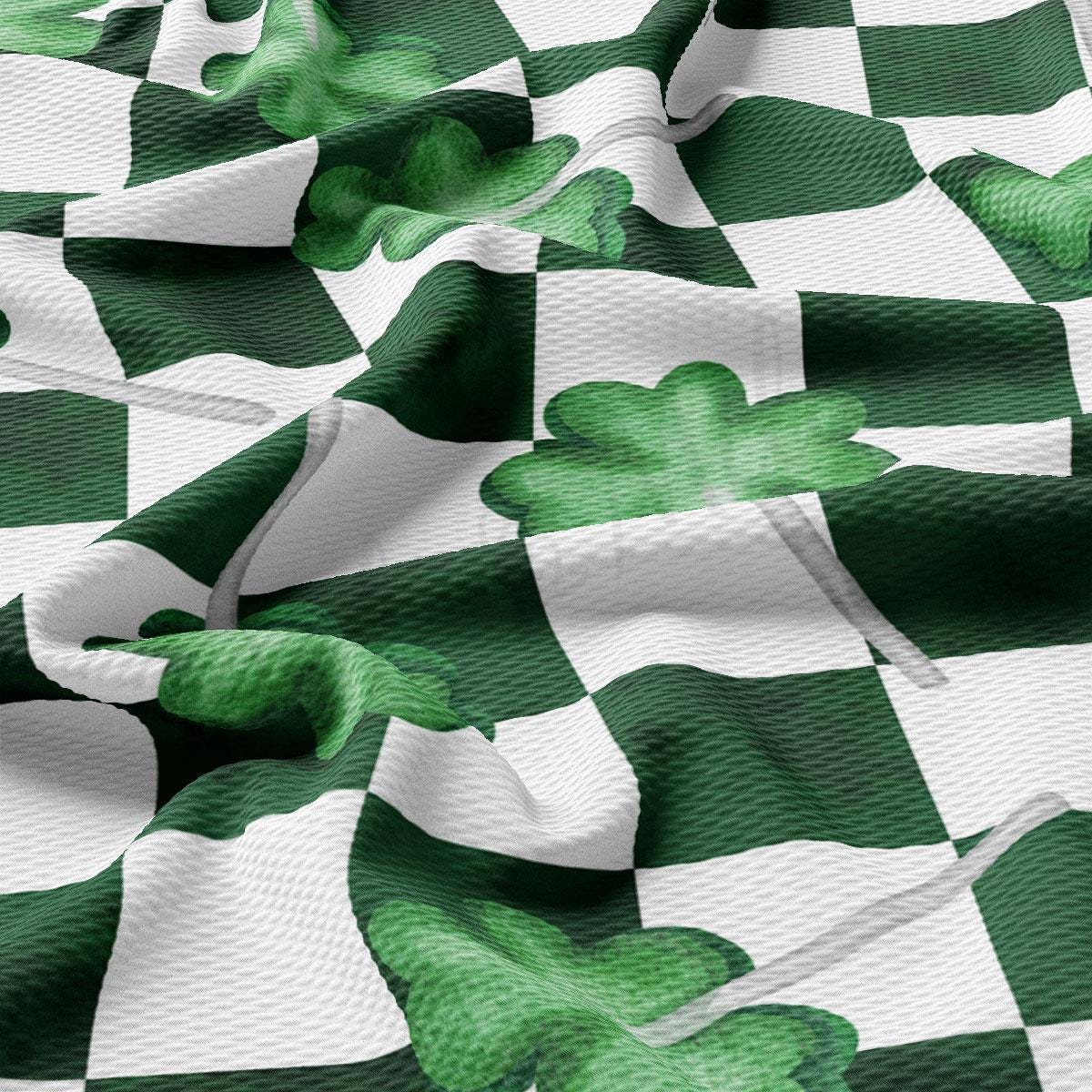 a green and white checkered fabric with shamrocks on it