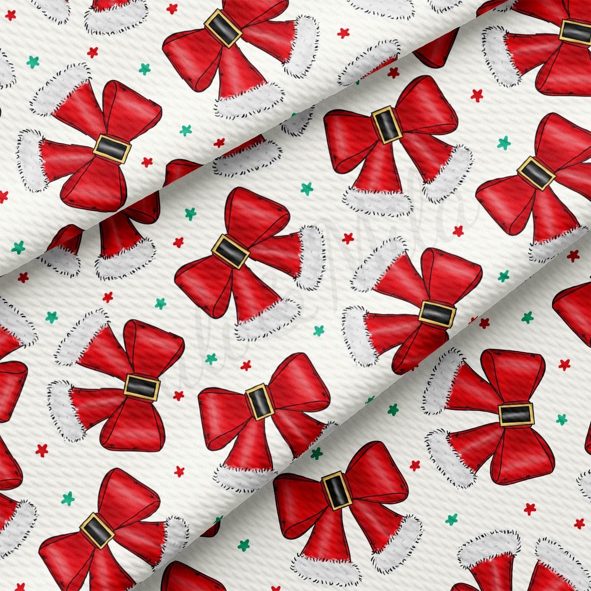 a repeating pattern of red bows with white fur trim, scattered across a white background.