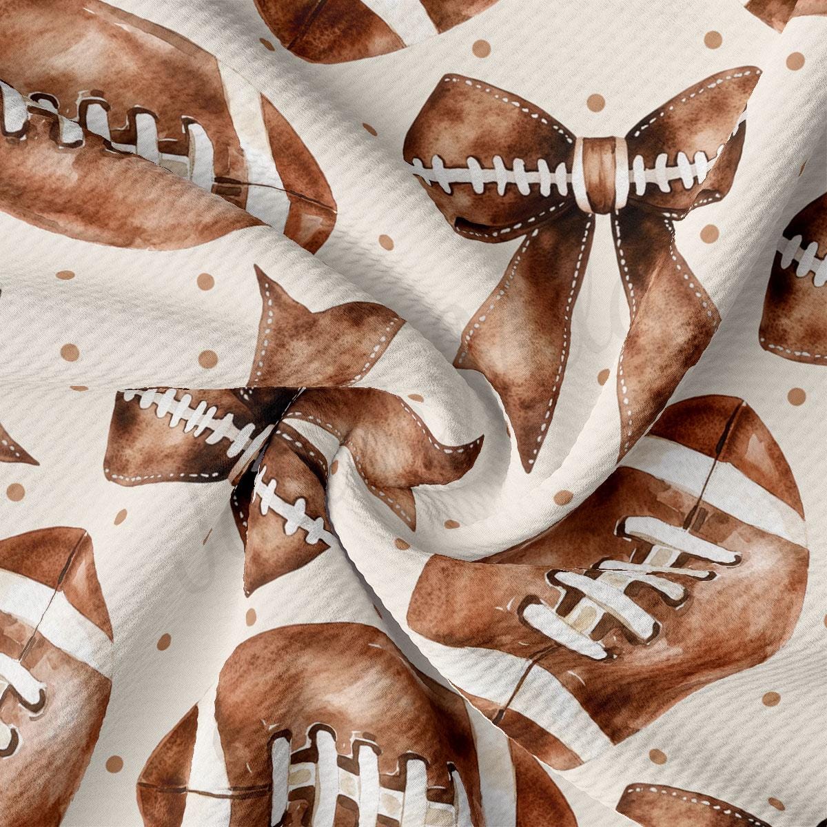 a close-up view of a fabric with a repeating pattern of brown footballs and brown bows.