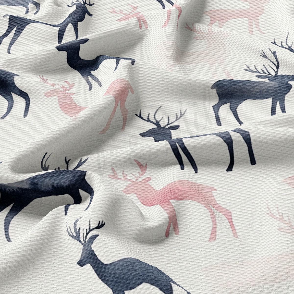 a close-up view of a fabric with a repeating pattern of deer silhouettes in shades of pink and black.
