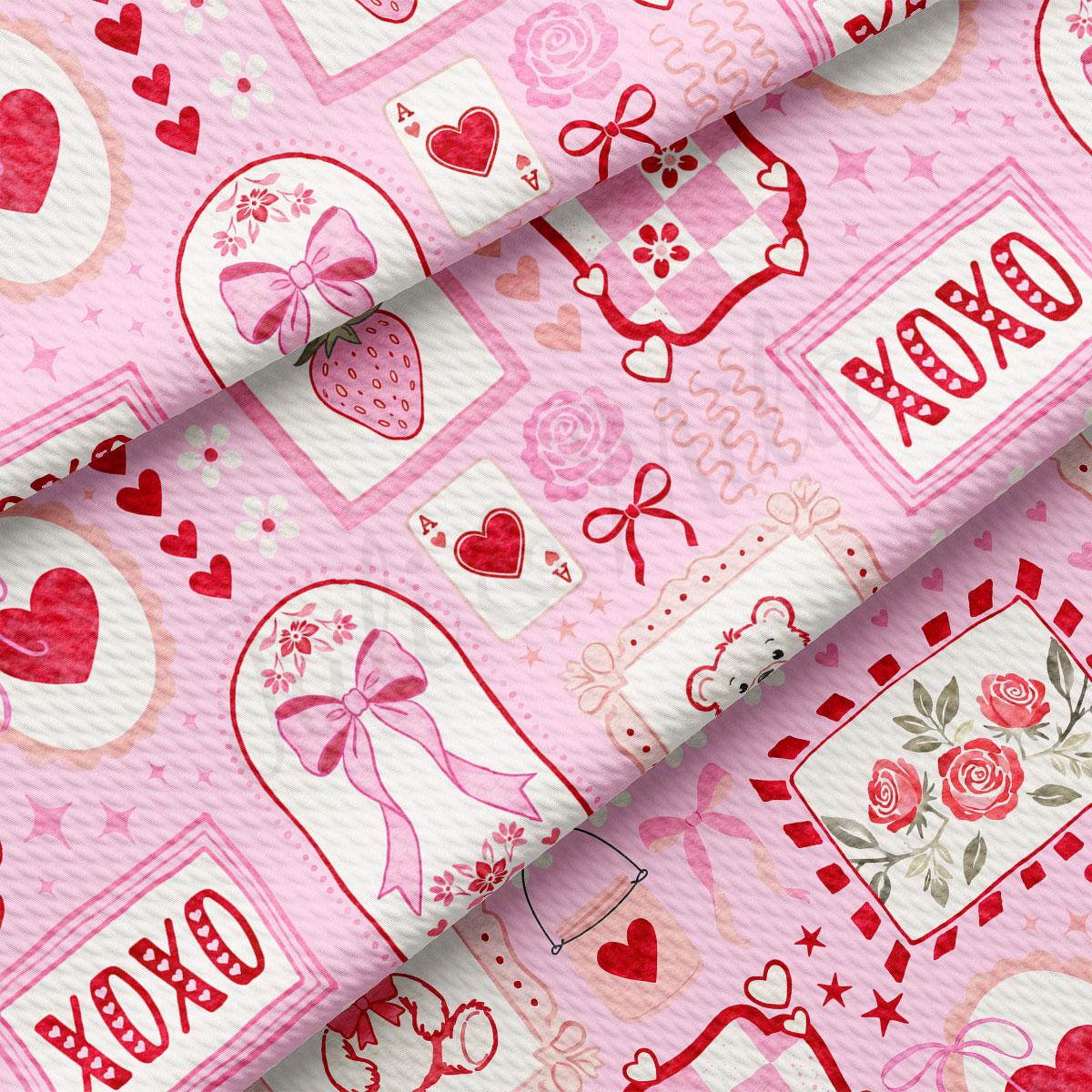 The image is a close-up of a fabric with a repeating pattern of pink and white elements, including hearts, bows, flowers, and the word "XOXO".
