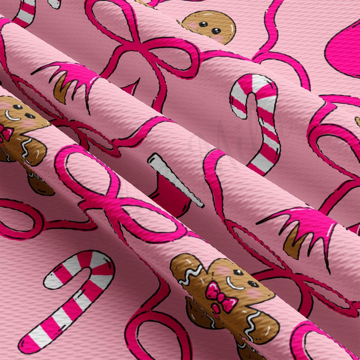 a close-up view of a fabric with a repeating pattern of pink ribbons and candy canes.