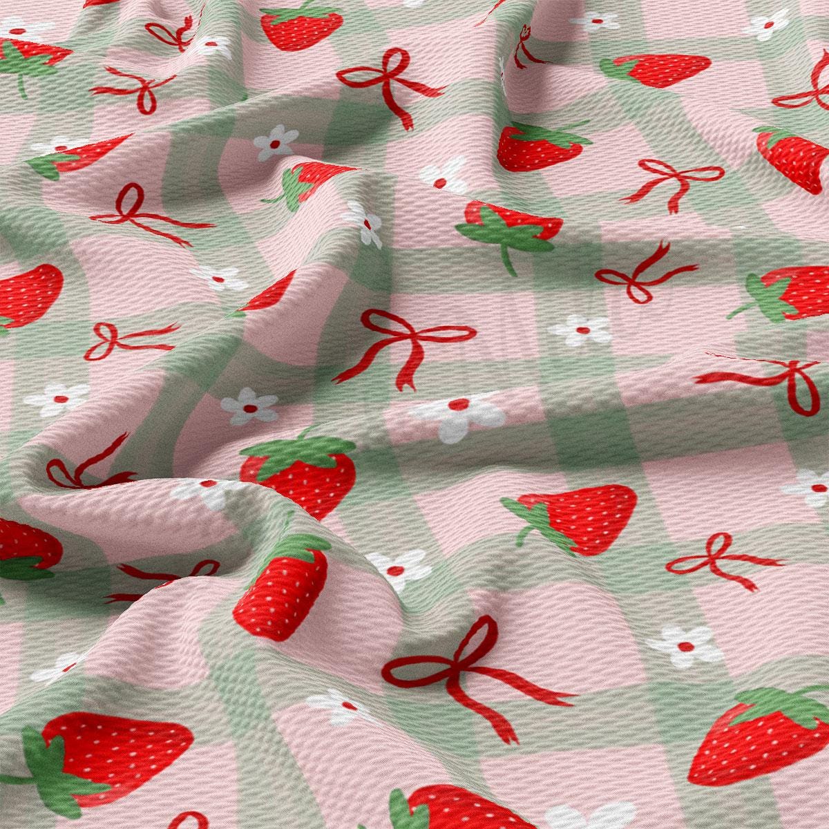a pink and green checkered fabric with strawberries on it