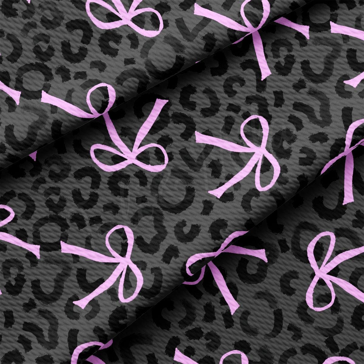 a pink ribbon on a black leopard print fabric