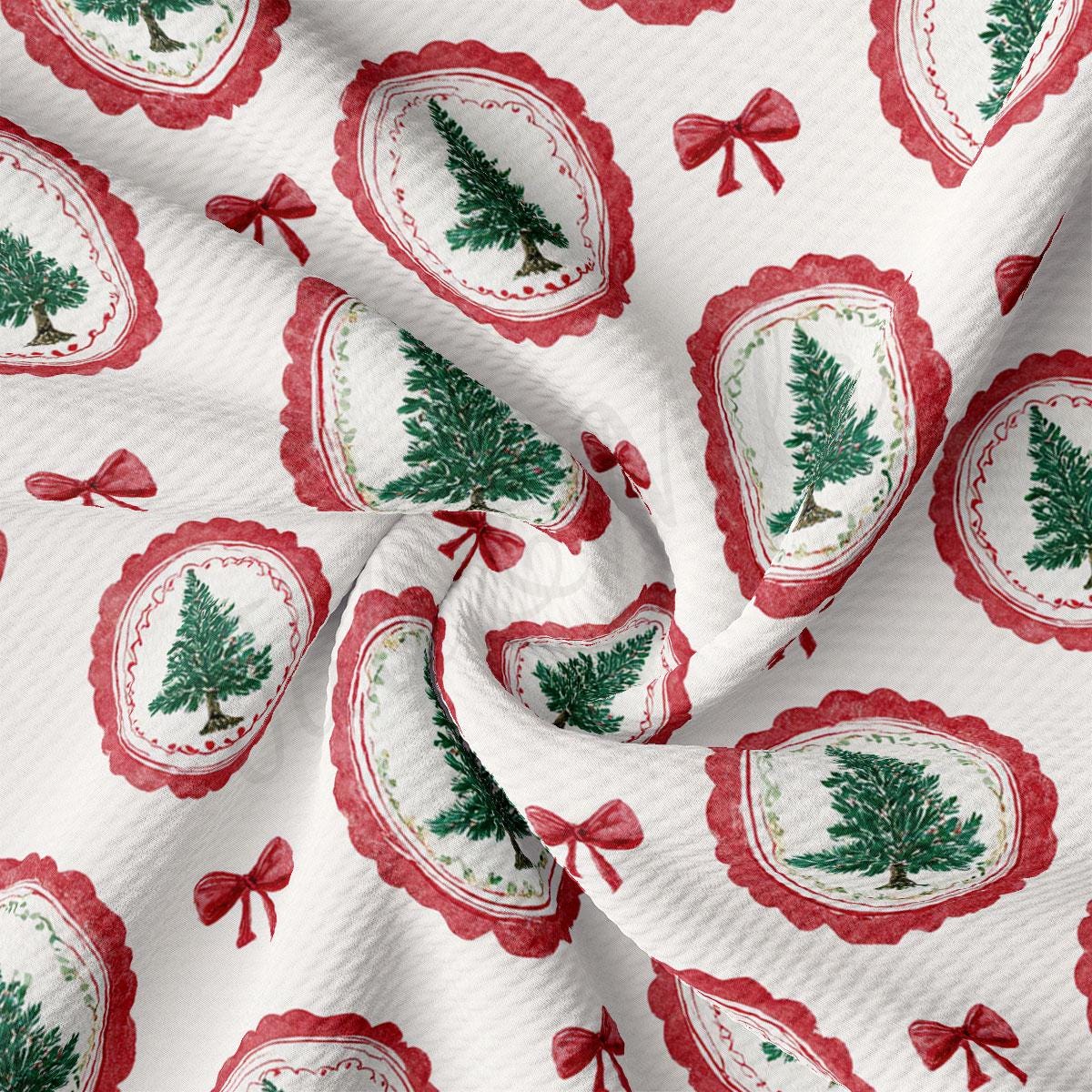 a close-up view of a fabric with a repeating pattern of Christmas trees and red bows.