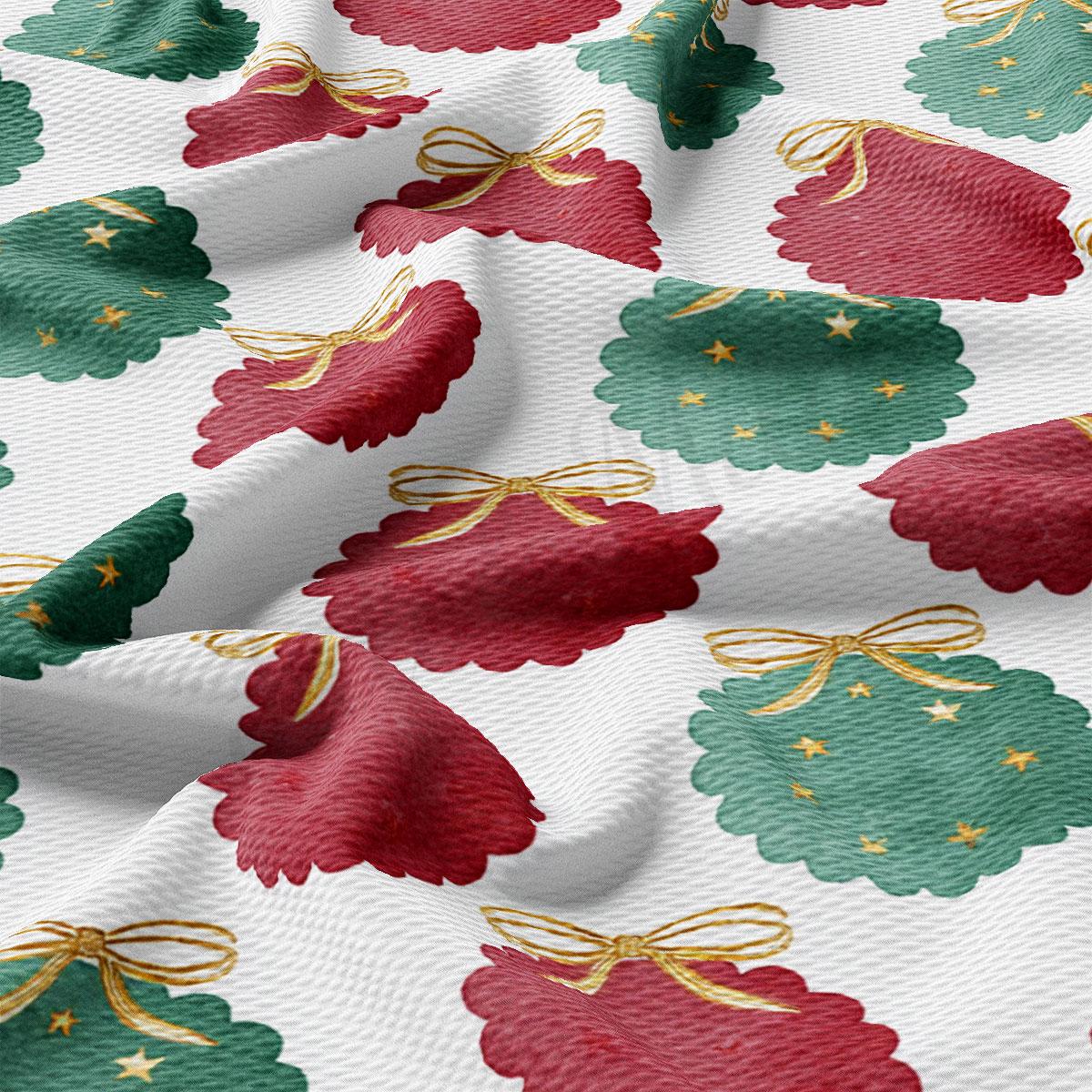 a close-up view of a fabric with a repeating pattern of Christmas-themed designs, including green and red Christmas trees, wreaths, and bows.