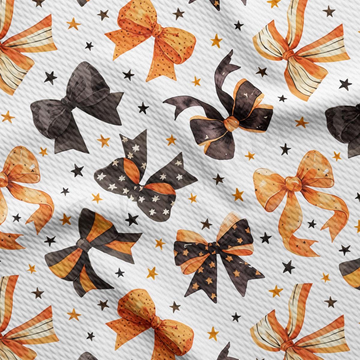 a repeating pattern of black and orange bows against a white background, with scattered stars.