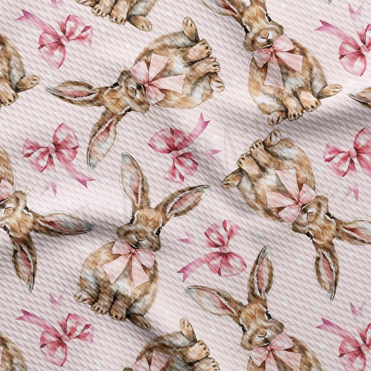 a pattern of rabbits with pink bows on a white background