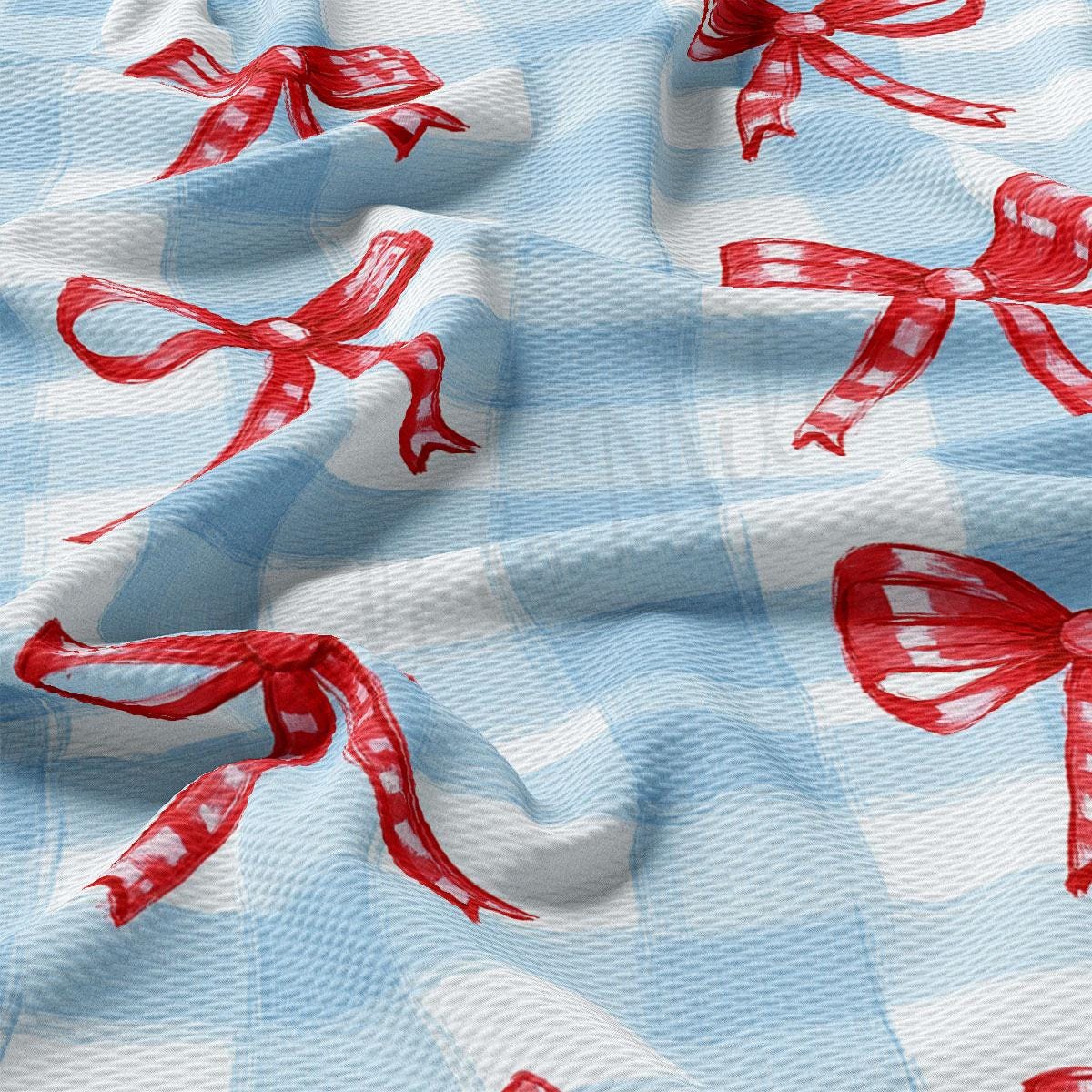 a blue and white checkered fabric with red bows