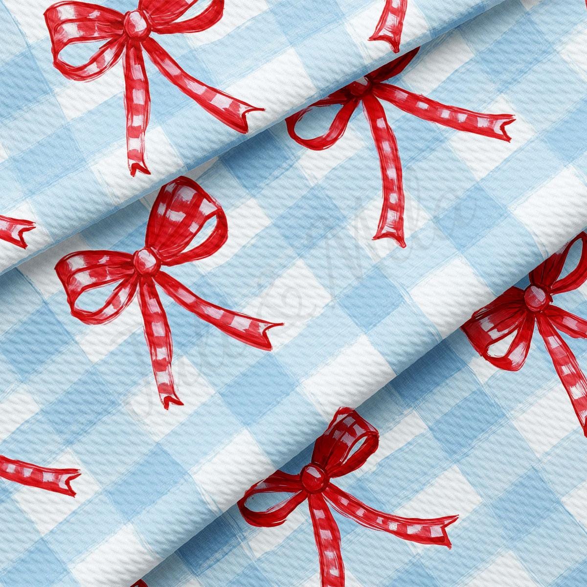 a blue and white checkered fabric with red bows