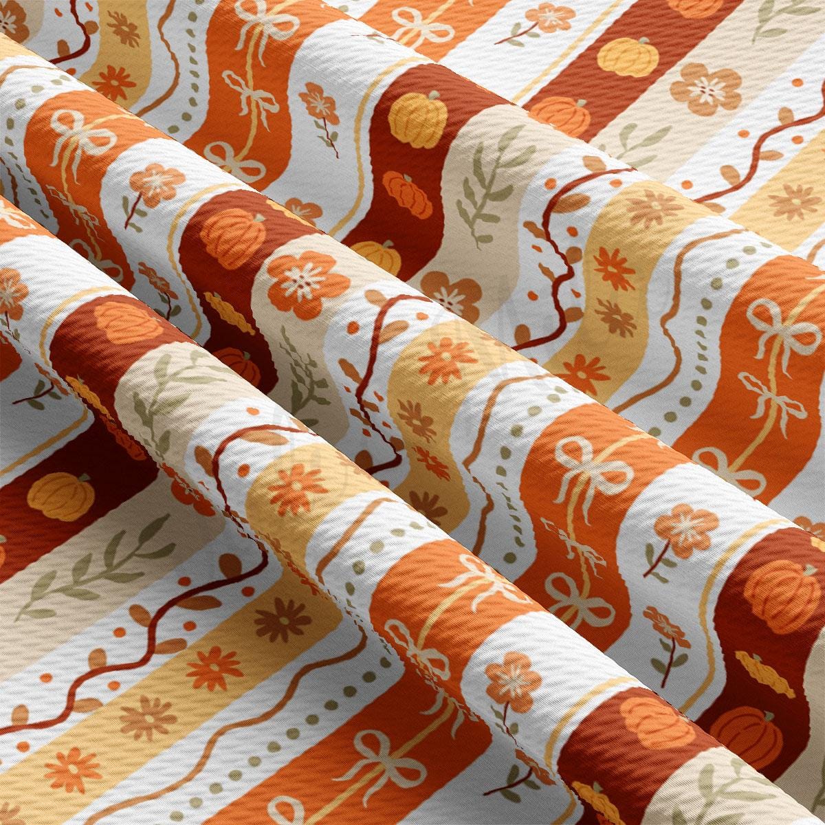 The image is a close-up view of a fabric with a repeating pattern of orange and white stripes, along with various autumn-themed elements such as leaves, flowers, and pumpkins.