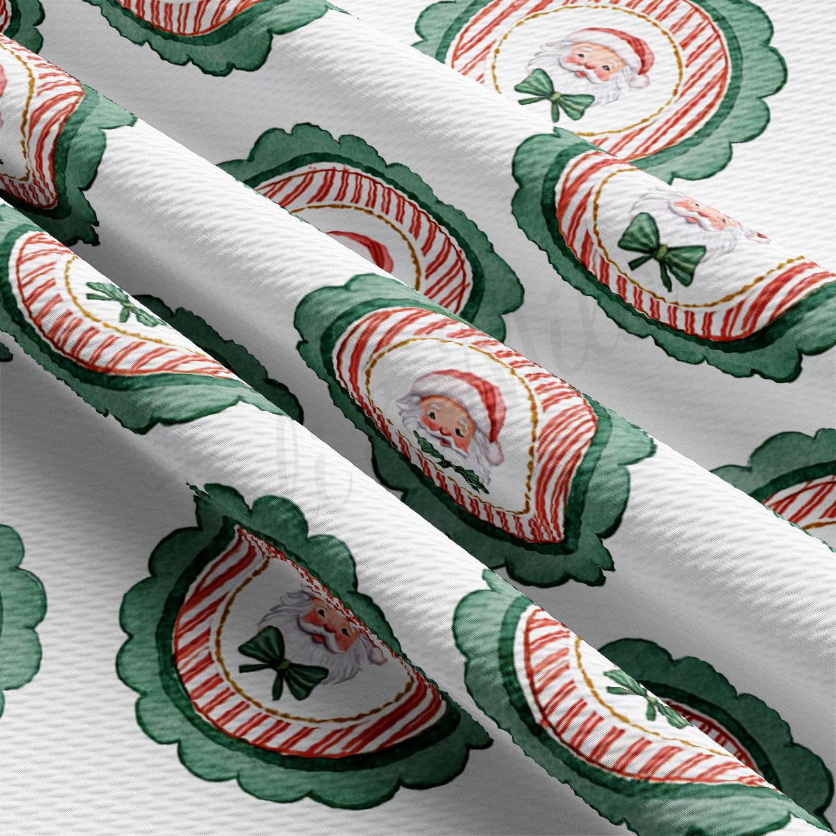 a close-up view of a fabric with a repeating pattern of Santa Claus and green leaves. The pattern is composed of multiple circles and lines, creating a festive and holiday-themed design.
