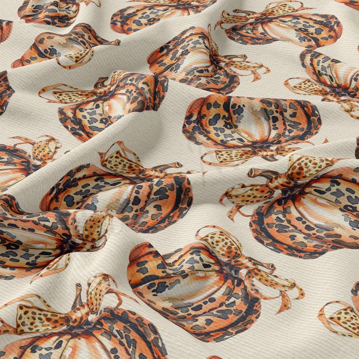 a repeating pattern of leopard-print pumpkins on a light-colored fabric.
